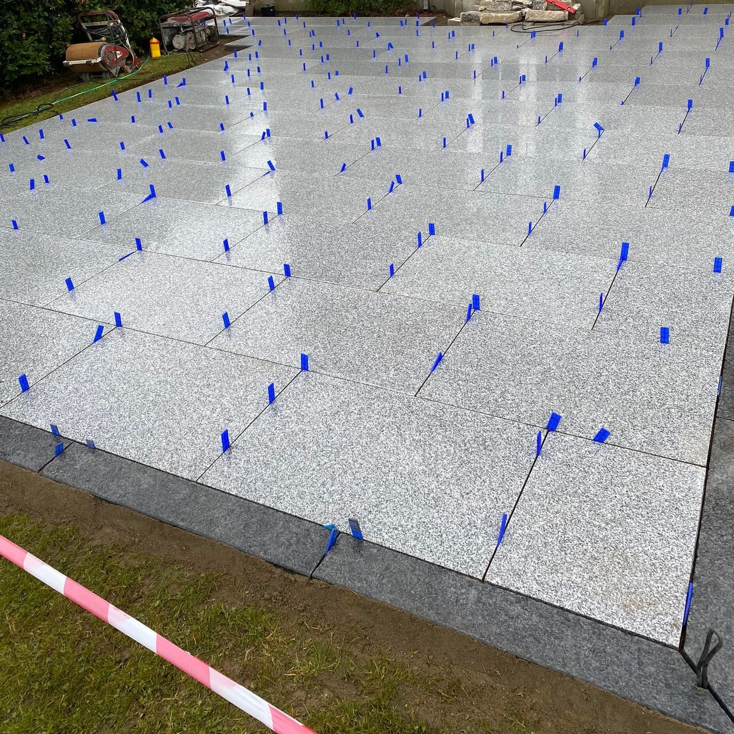 Patio under construction. Border completed using Black Granite Pin Kerbs
