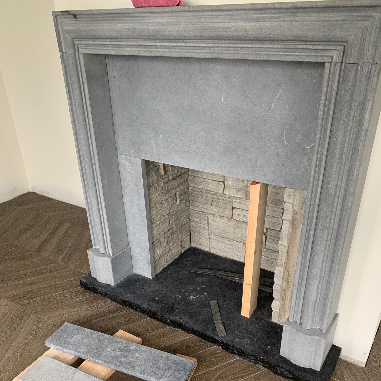 Architectural Blue Limestone Fireplace Surround with a Black Limestone Hearth and Silver Quartzite Stoneer Cladding inset.