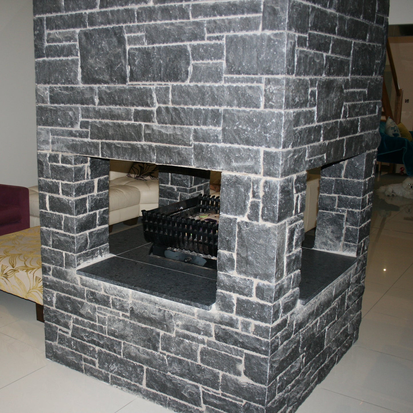 Internal stone fireplace cladded in Blue Limestone Stoneer Cladding.