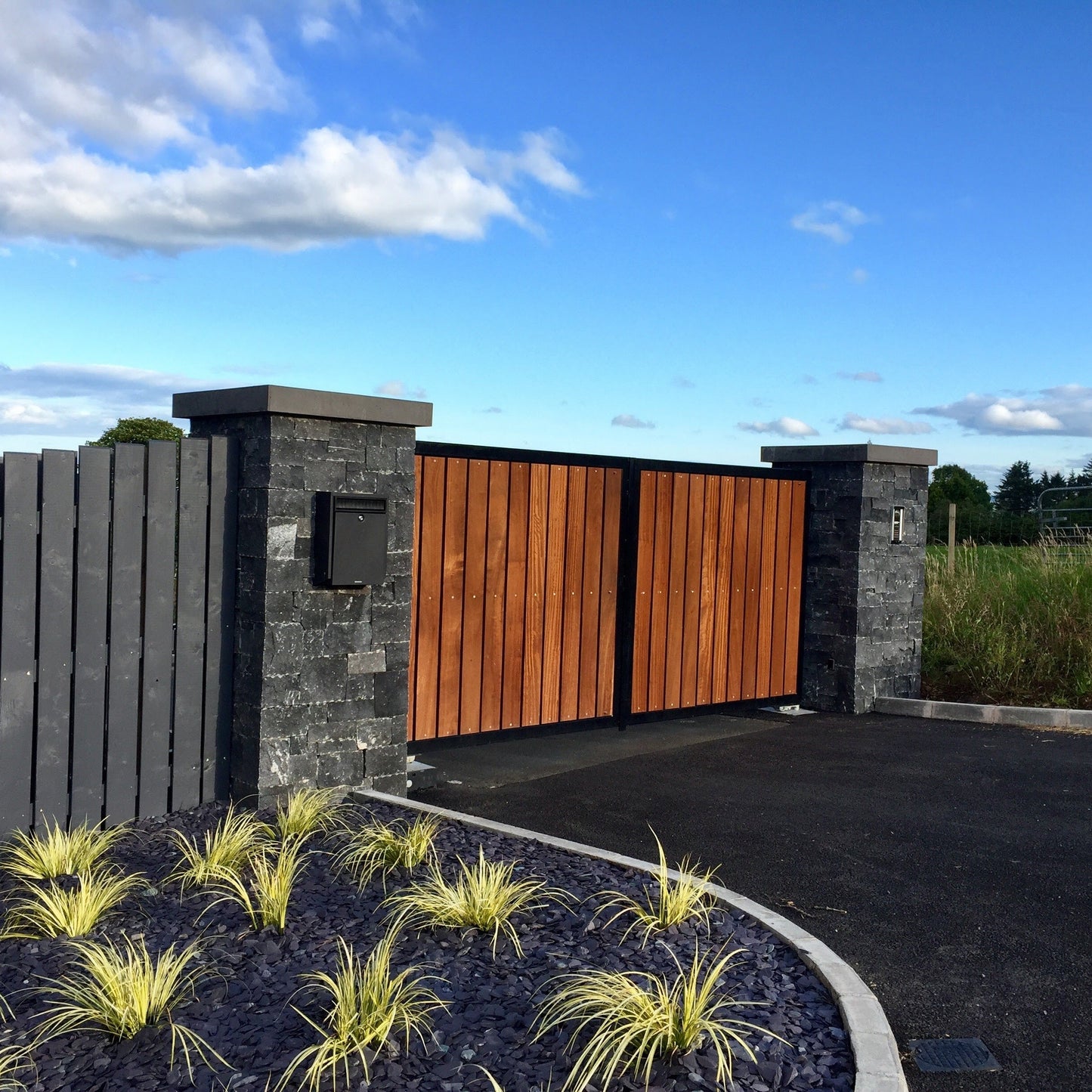 Entrance pillars completed using Blue Limestone Stoneer Cladding and bespoke Limestone pillar cap.