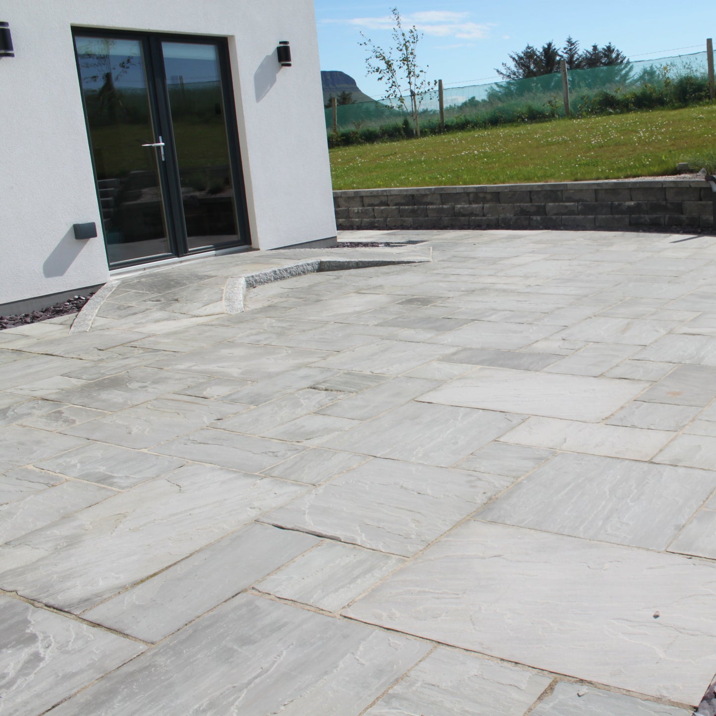 Patio area and ramp finished in Grey Sandstone Paving.