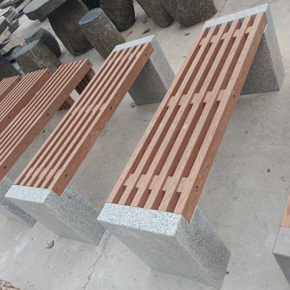 A PVC wood bench with silver granite legs, displayed in an outdoor setting.