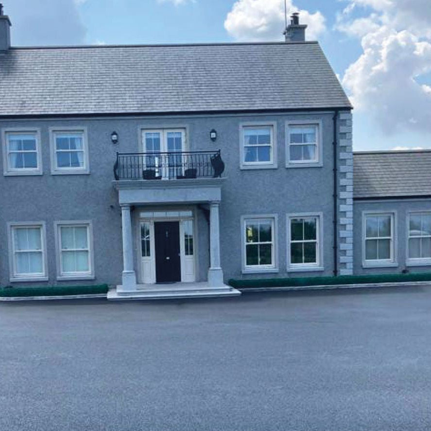 Two storey house with Bespoke Silver Granite Window Surrounds and Portico.