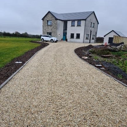 Driveway featuring 14mm Gold Donegal Quartzite Stone Chipping leading towards a modern new build. 