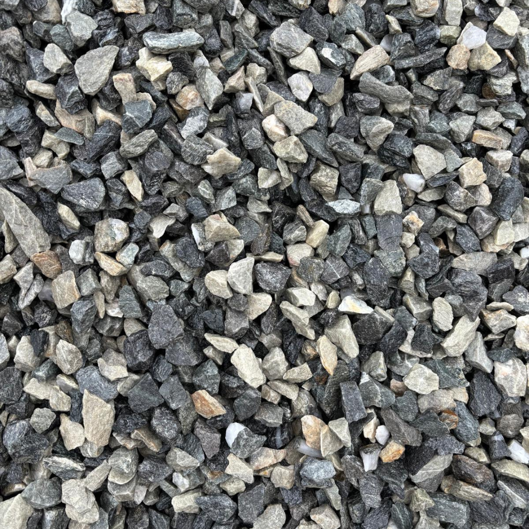 A close-up image of Black Ice Chippings, showing a mix of dark black and dark grey stones, paired with lighter grey to white stones.