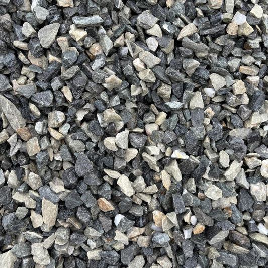 A close-up image of Black Ice Chippings, showing a mix of dark black and dark grey stones, paired with lighter grey to white stones.