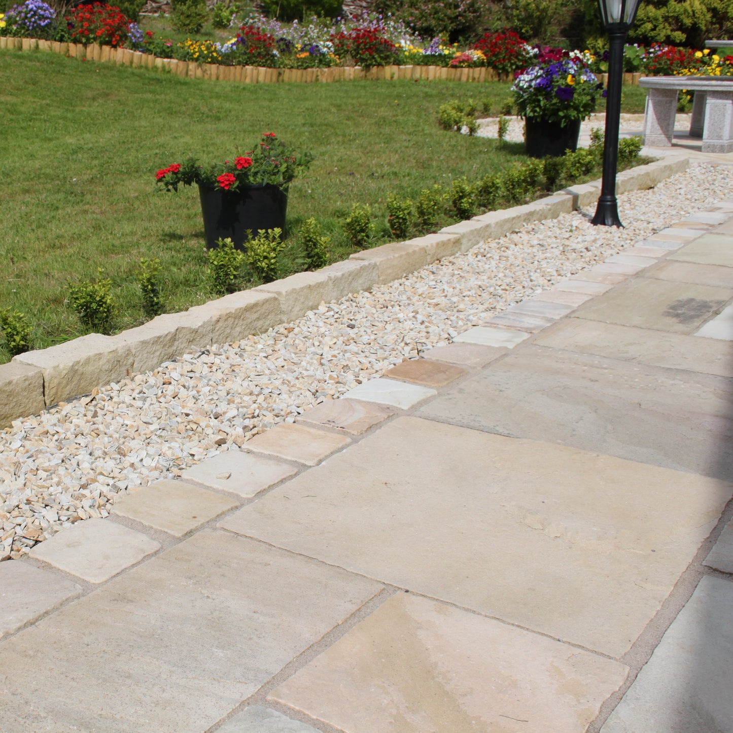 Garden and patio area with decorative patio edging featuring 20mm Gold Donegal Quartzite Stone Chipping. 