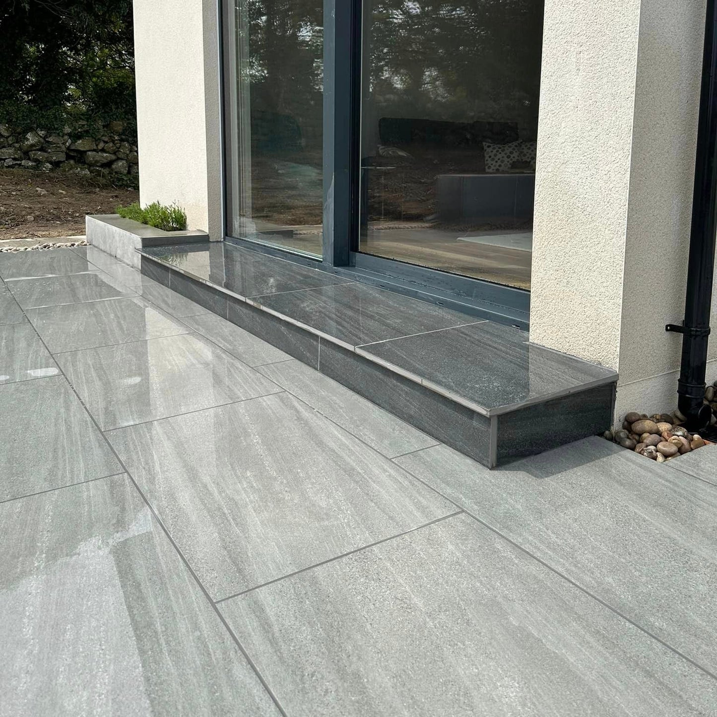 Patio leading up to house step. Paving is Ashen Jewel Range Porcelain Paving tiles.