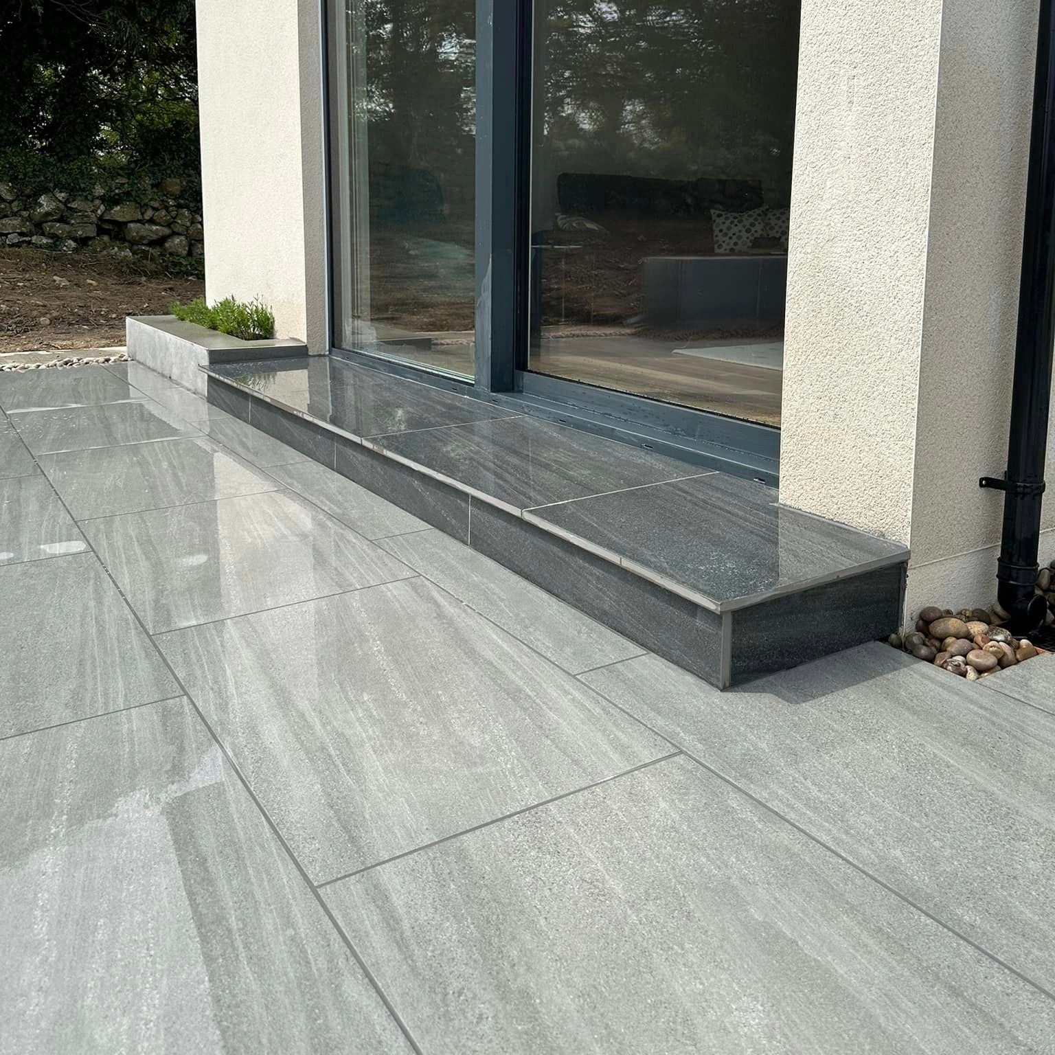 Patio leading up to house step. Paving is Ashen Jewel Range Porcelain Paving tiles.