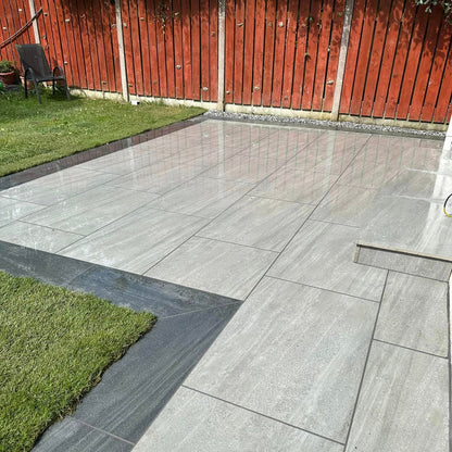 Small patio area featuring Ashen Jewel Range Porcelain Paving. 