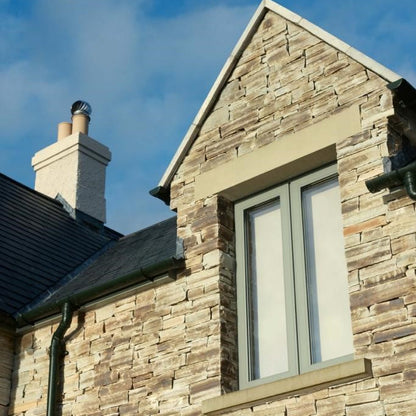 Close up of a window detail with Atlantic Grey Donegal Quartzite Machined walling stone. 