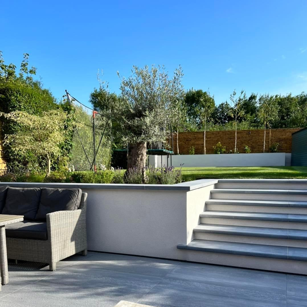 Bespoke Blue Limestone Steps with a sanded finish leading up to a garden. 