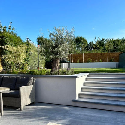 Bespoke Blue Limestone Steps with a sanded finish leading up to a garden. 