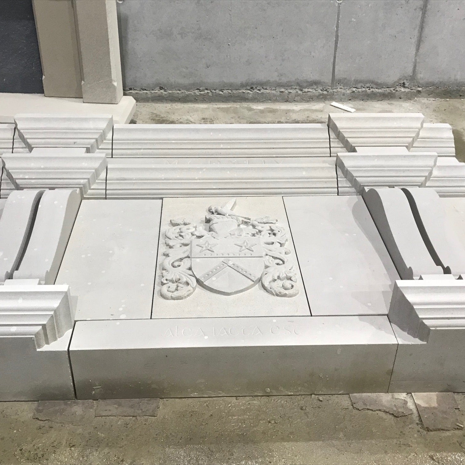 Architectural Sandstone Mantel with close up of one carved family crest in McMonagle Stone's workshop. 