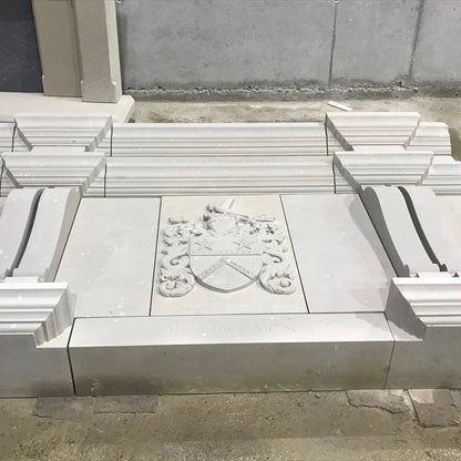Architectural Sandstone Mantel with close up of one carved family crest in McMonagle Stone's workshop. 