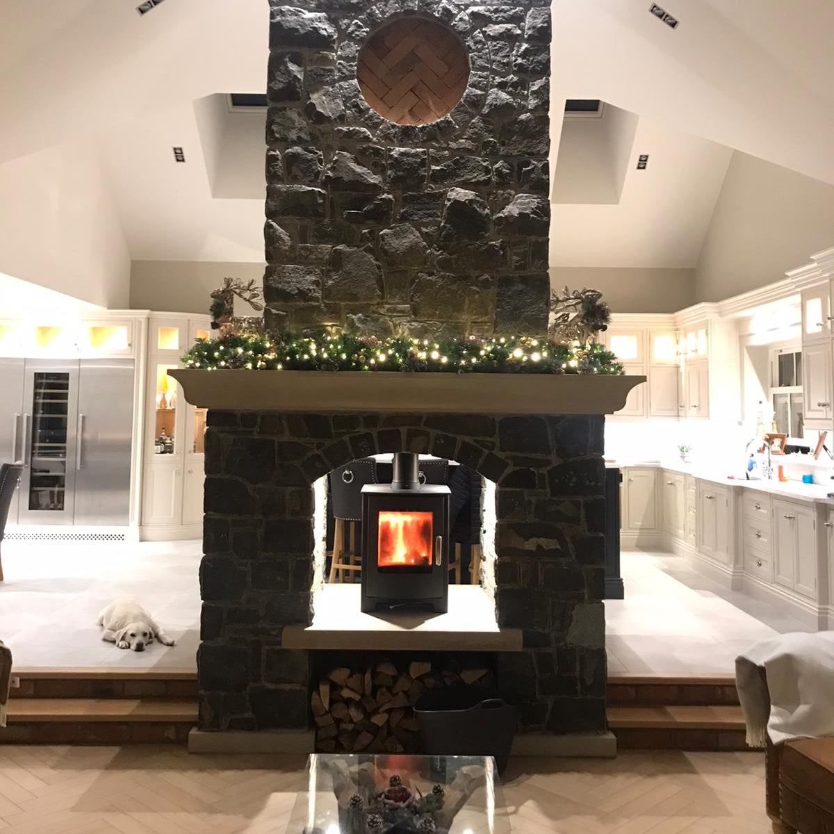 Bespoke Mountcharles Sandstone Hearth and Mantel on a beautiful double sided natural stone fireplace.