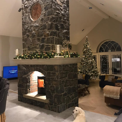Bespoke Mountcharles Sandstone Hearth and Mantel on a beautiful double sided natural stone fireplace.