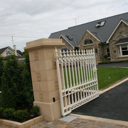 Bespoke sandstone pillar with white gate. Pillar completed with bespoke sandstone cap. 