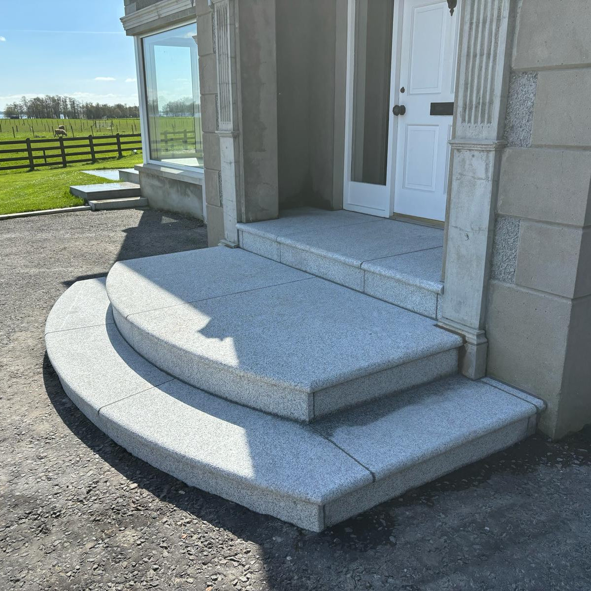 Bespoke Silver Granite Steps with curved design at front entrance.