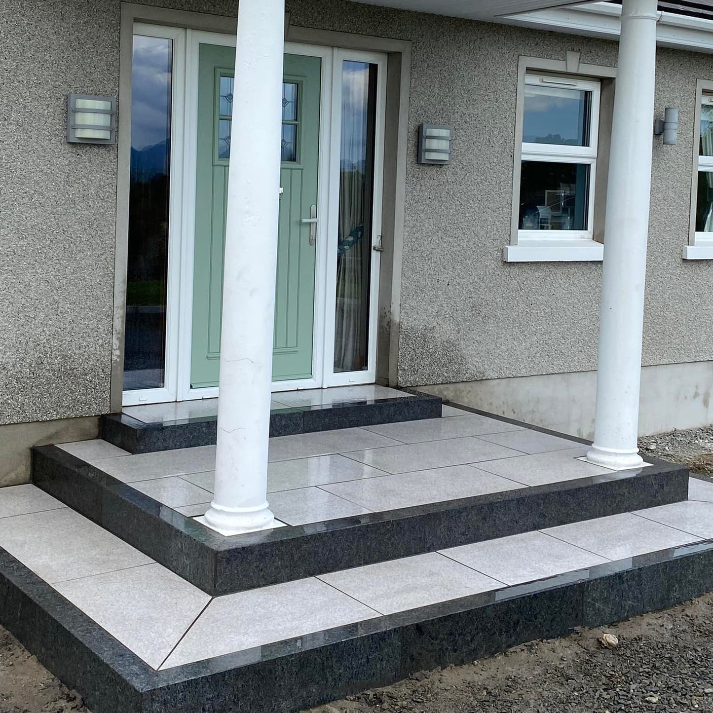Front door steps completed with black granite kerbing. 