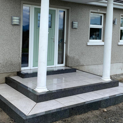 Front door steps completed with black granite kerbing. 