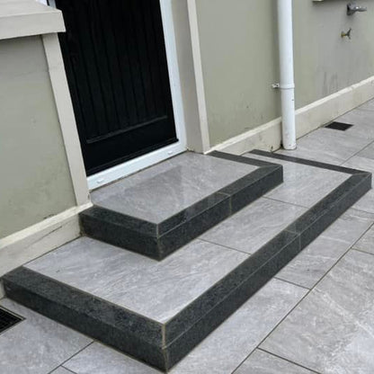 Porcelain steps completed using Black Granite Kerbs. 