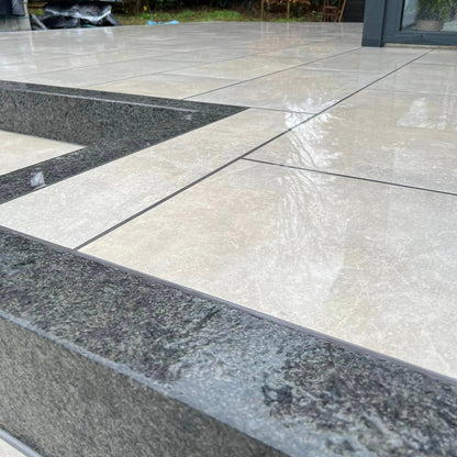 Close up of porcelain patio with Black Granite Kerbing. 