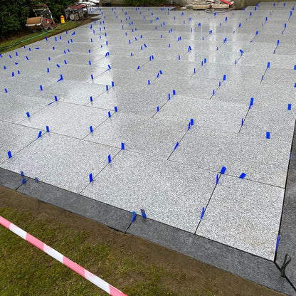 Patio under construction. Border completed using Black Granite Pin Kerbs