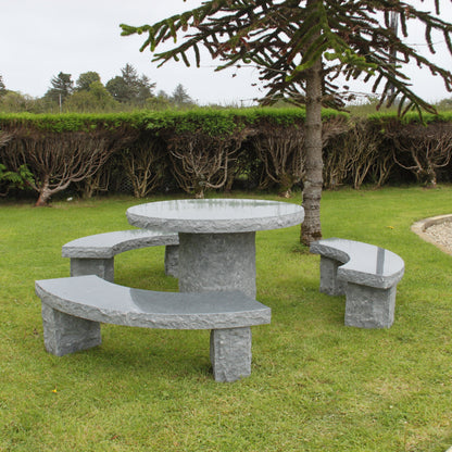 Garden with tree and hedges featuring a Black Granite Table and Bench Set. 