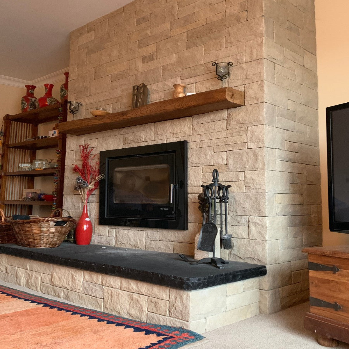 Sandstone Fireplace with Bespoke Black Limestone Hearth with a Rockfaced edge