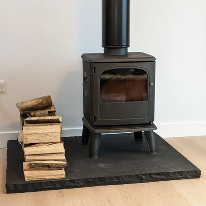 Contemporary Black Limestone Hearth with a Free Standing Stove. 