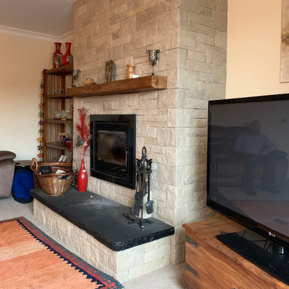 Sandstone Fireplace with Bespoke Black Limestone Hearth with a Rockfaced Edge