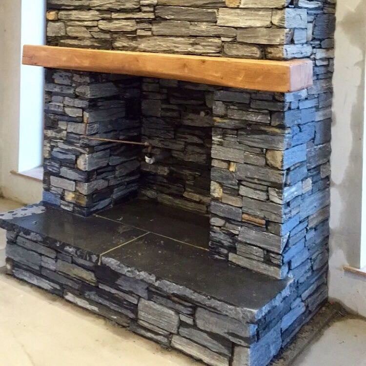Bespoke Black Limestone Hearth on a slate fireplace. 