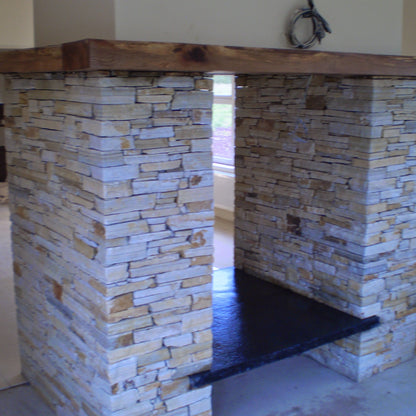 Bespoke Black Limestone Hearth on a double sided Donegal Quartzite Fireplace. 