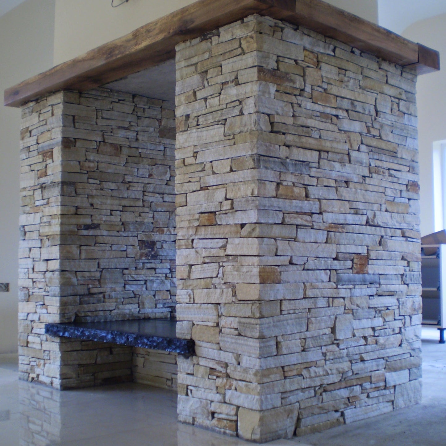 Bespoke Black Limestone Hearth on a Donegal Quartzite Double Sided Fireplace