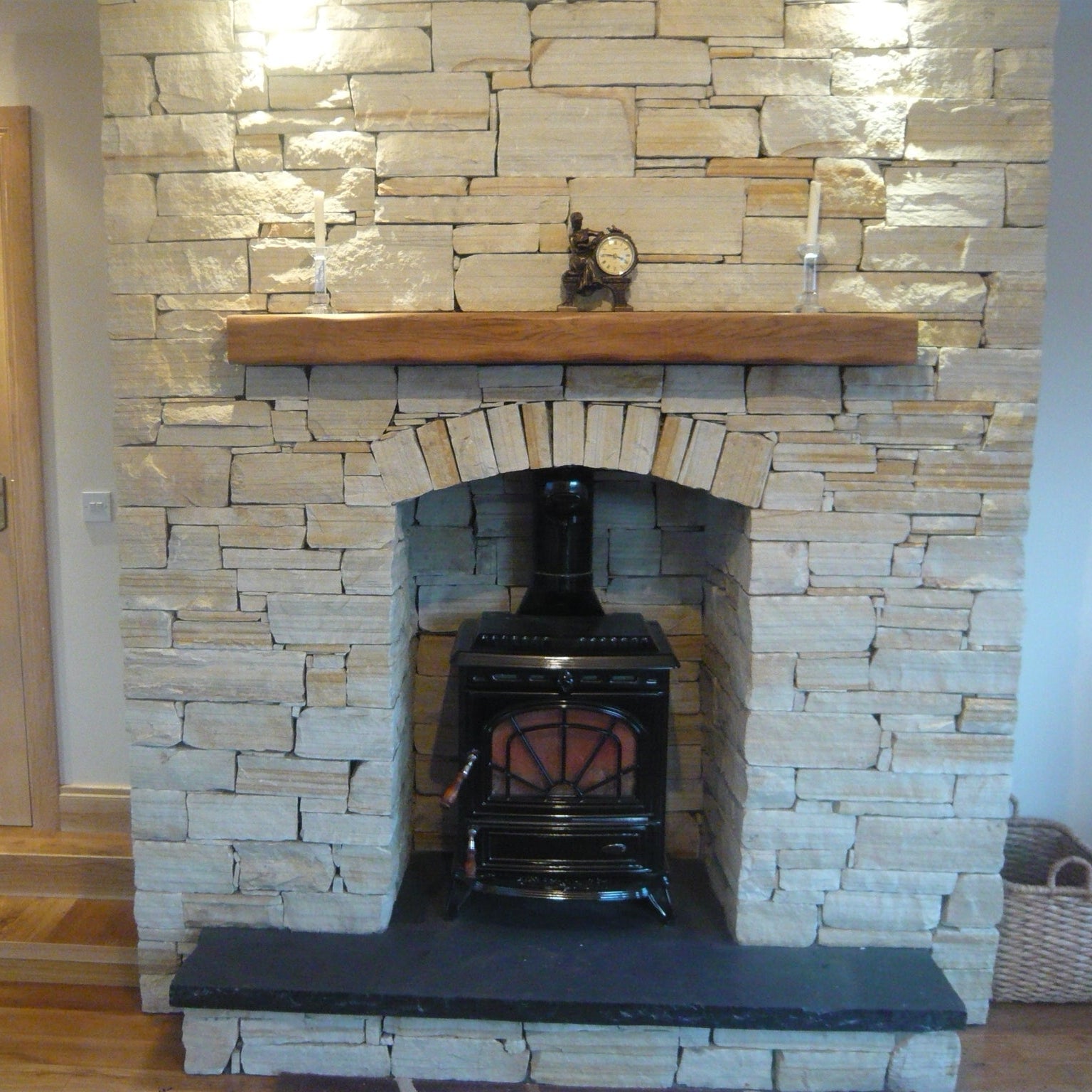 Bespoke Black Limestone Hearth on a Gold Donegal Quartzite Fireplace