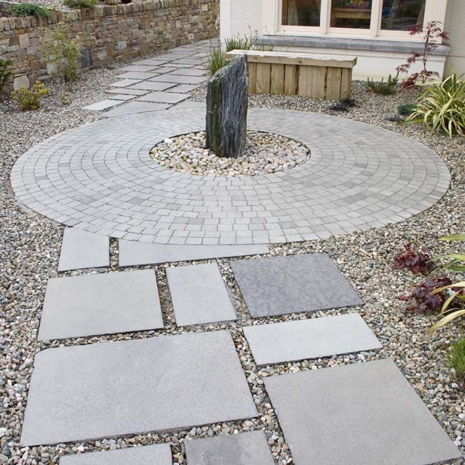 Pathway designed using Black Limestone Paving in patio pack sizes and cobbles. 