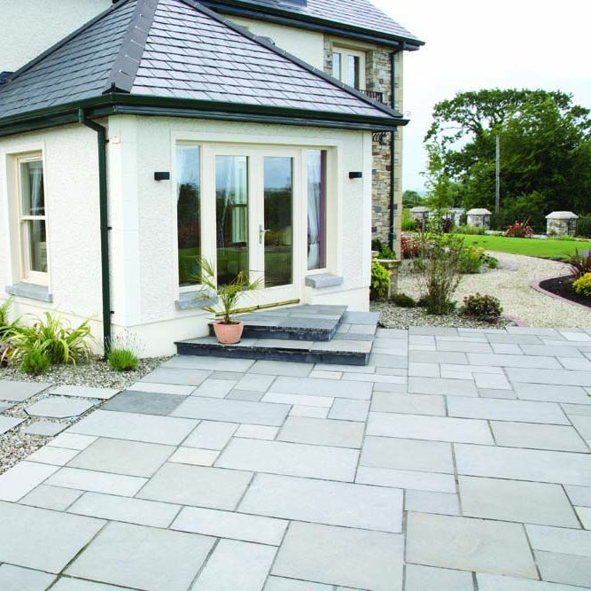 Modern garden featuring a patio area with Black Limestone Paving installed. 