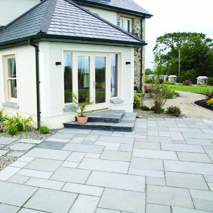 Modern garden featuring a patio area with Black Limestone Paving installed. 