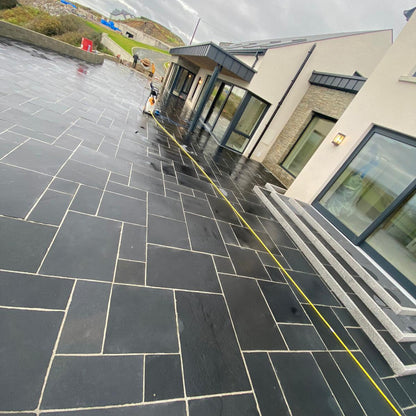 Large patio area completed using Black Limestone Paving. 