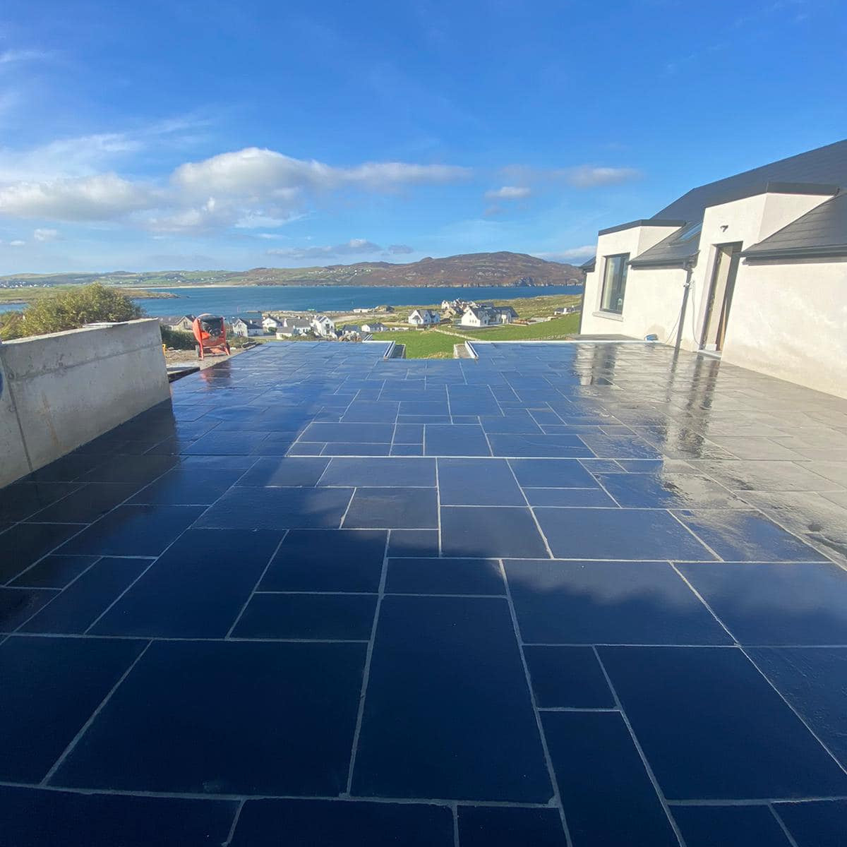 Large balcony area paved in Black Limestone Paving in mixed pack sizes. 
