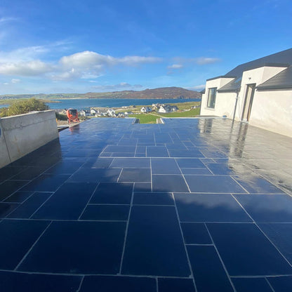 Large balcony area paved in Black Limestone Paving in mixed pack sizes. 