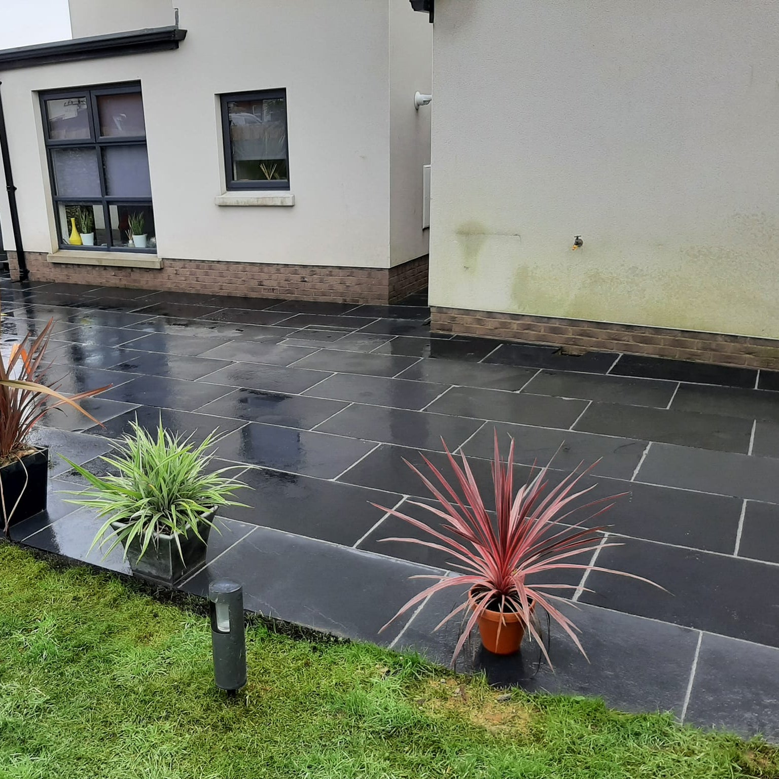 Patio area featuring Black Limestone Paving in 900 x 600mm size. 