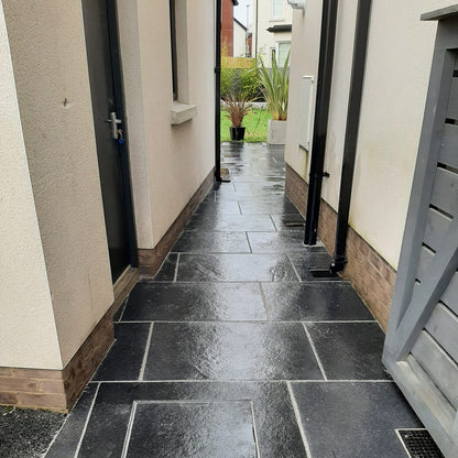 Pathway leading to patio area completed using Black Limestone Paving in 900 x 600mm size.
