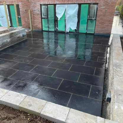 Patio area completed using Black Limestone paving in 900 x 600mm size. 