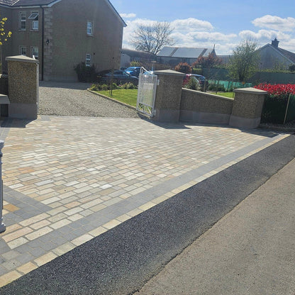 Driveway entrance featuring Donegal Quartzite Cobbles and Black Limestone Cobbles in 100 x 100mm size on a sunny dry day. 