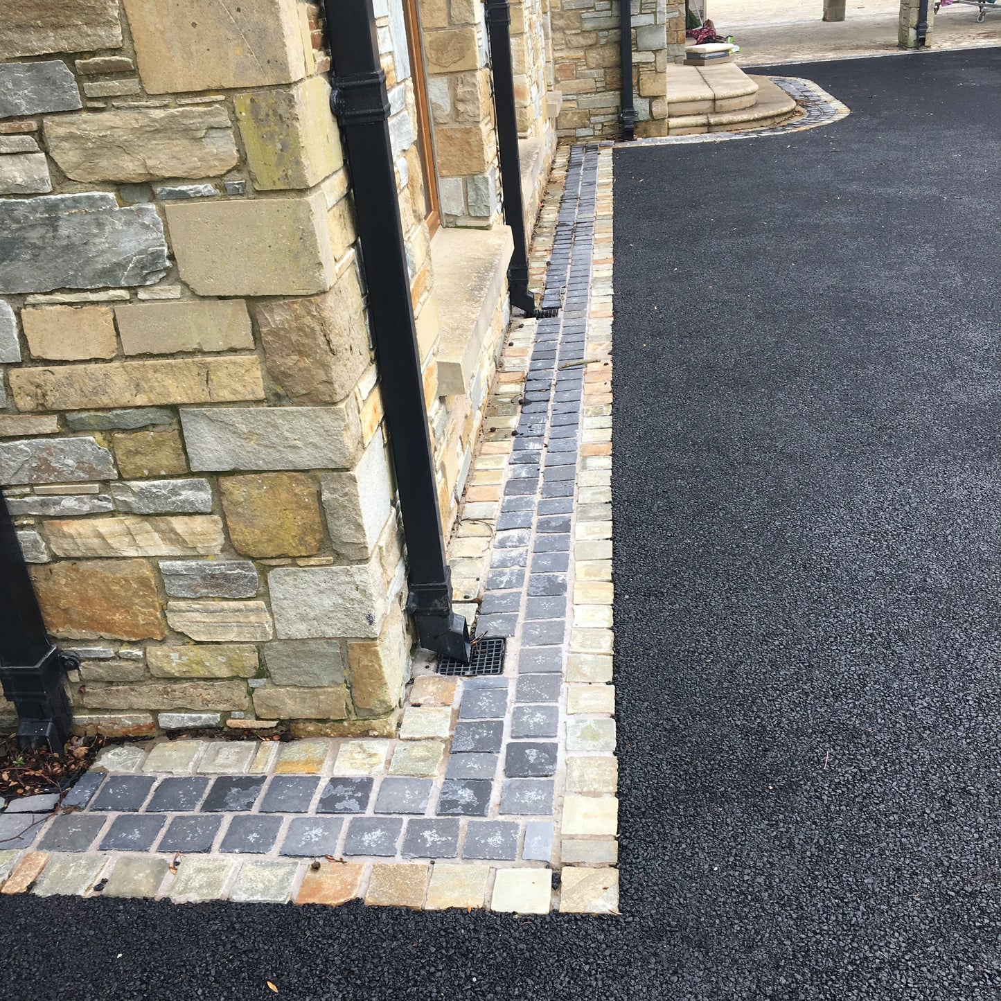 Driveway border featuring Black Limestone Cobbles in 100 x 100mm size. 