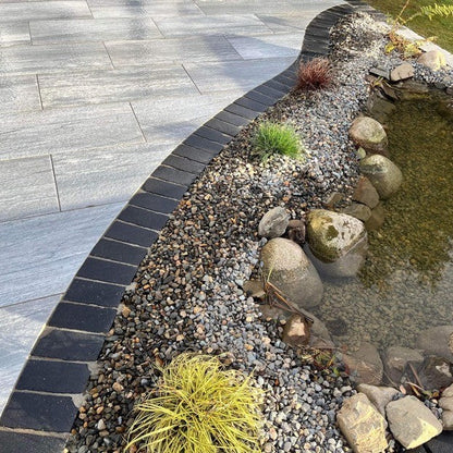 Patio water feature bordered with Black Limestone Paving Cobbles in 200 x 100mm size.