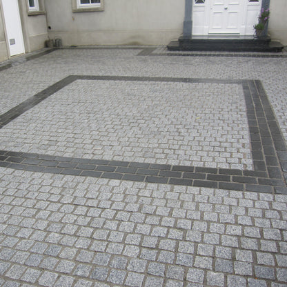 Patio area featuring a square design completed using Black Limestone Paving Cobbles.  