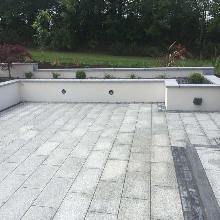 Silver Granite Patio with Black Granite Border completed using a double row of 200 x 100mm Black Granite Cobbles